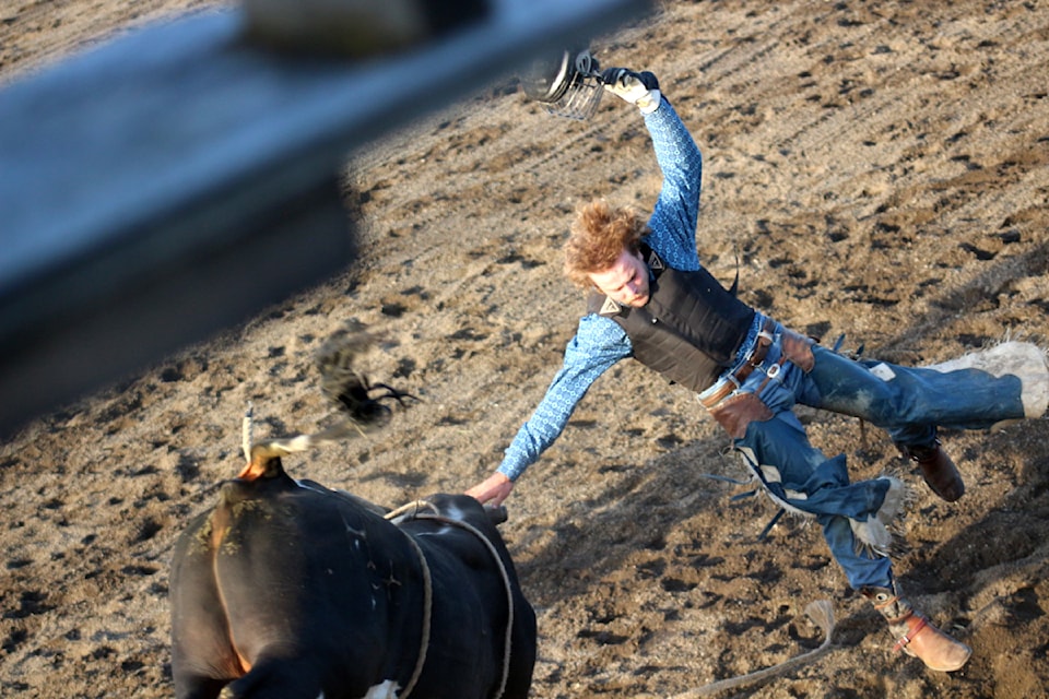 Connor Glueck loses his helmet after being bucked off a bull during the third annual Logan Parent Bulls and Barrels. (Misha Mustaqeem photo - simplymastery)