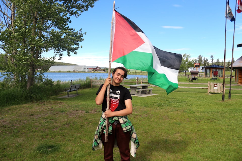 Karl Lundsbye, the organizer of the March for Peace, with the flag of Palestine near the South Cariboo Visitors Centre 