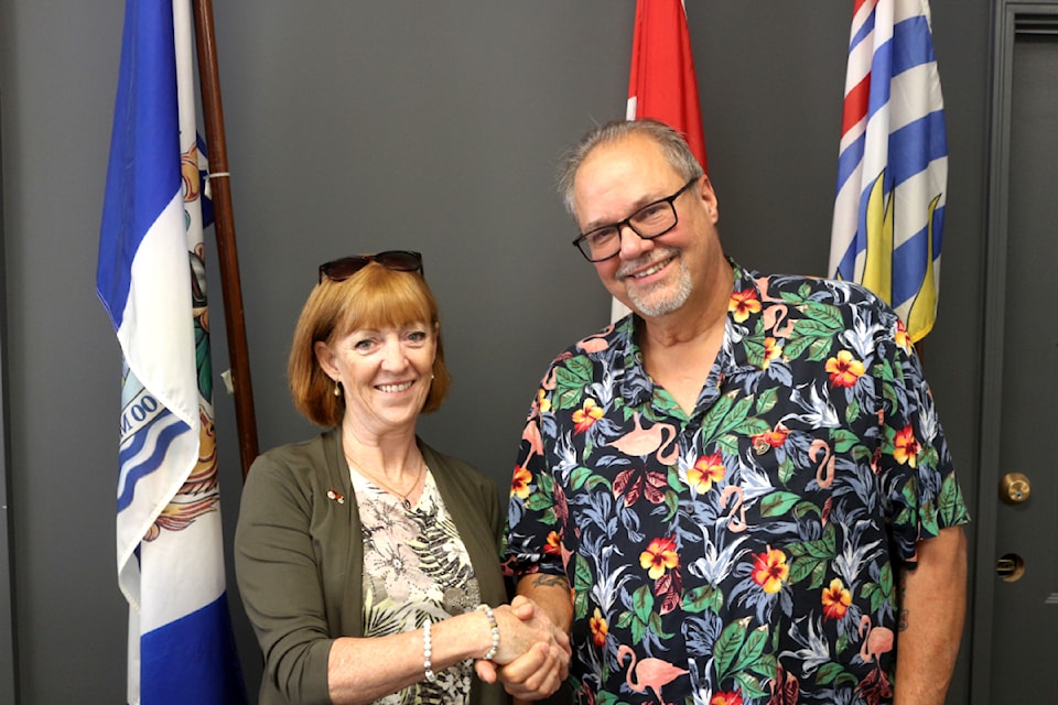 District of 100 Mile House Mayor Maureen Pinkney welcomes Coun. Marty Norgren, the newest councillor on the District of 100 Mile House council. Norgren won his seat in a by-election last month. (Misha Mustauqeen photo - simplymastery)