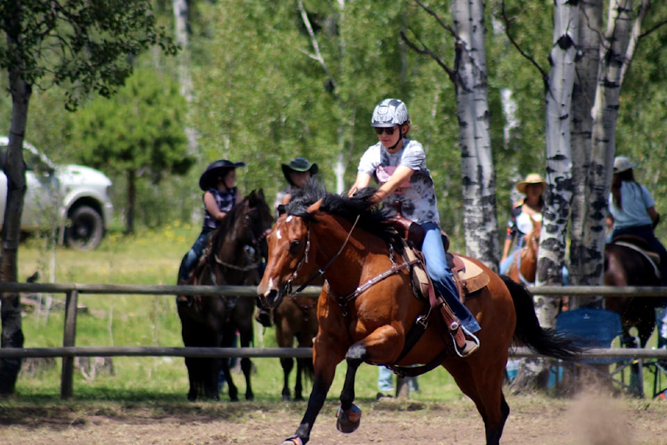 Reilly Herperner, a rider from Lone Butte, rides her horse during the Watch Lake/Green Lake gymkhana in 2024. (Misha Mustaqeem photo - simplymastery)