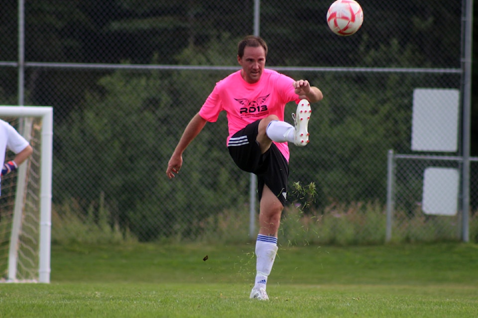 Weekend Warriors player Sean Glanville kicks the ball during the first annual Reid Davidson Memorial Soccer Tournament at 100 Mile Soccer Fields. 