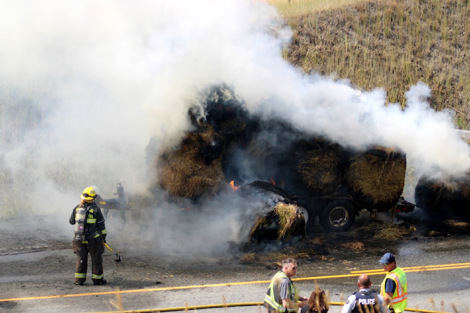 Firefighters from the 108 Mile Ranch VFD and the 100 Mile House Fire Rescue attempt to put out a hay fire north of Back Valley Rd at Highway 97 near 105 Mile Lake.