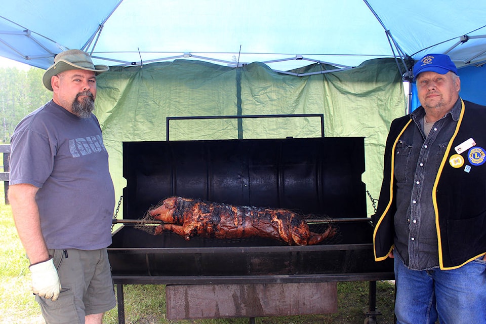 12267231_web1_18060514-omh-pigroast-web