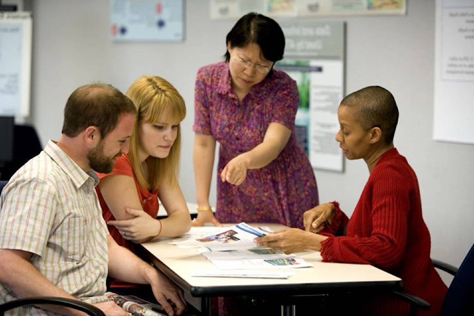 16017455_web1_three-women-and-one-man-working-in-office-725x483