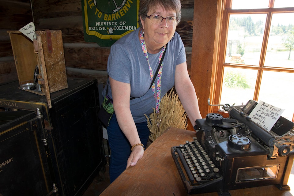 Sheila Williams, caretaker of the 108 Heritage Site, shows off the Royal typewriter used in the making of the first 100 Mile newspaper. (Kelly Sinoski photo, 100 Mile Free Press)