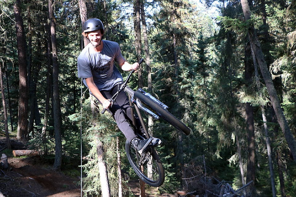 Soren Farenholtz of Kamloops grins as he dirt jumps at Slope Line Bike Park Saturday morning. (Patrick Davies photo - 100 Mile Free Press)