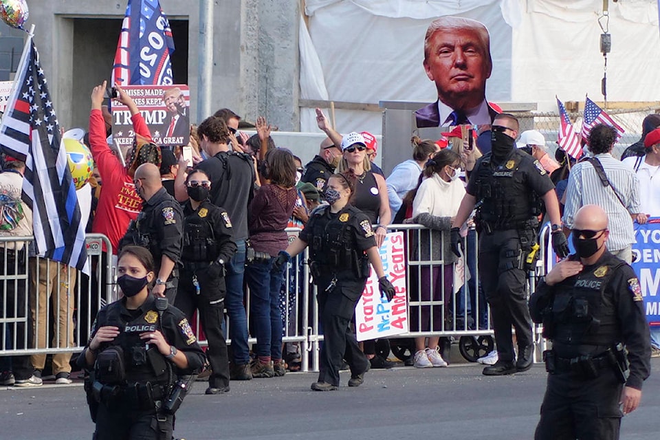 President Donald Trump supporters gather outside Walter Reed National Military Medical Center in Bethesda, Md., Sunday, Oct. 4, 2020. Trump was admitted to the hospital after contracting COVID-19. (AP Photo/Anthony Peltier)