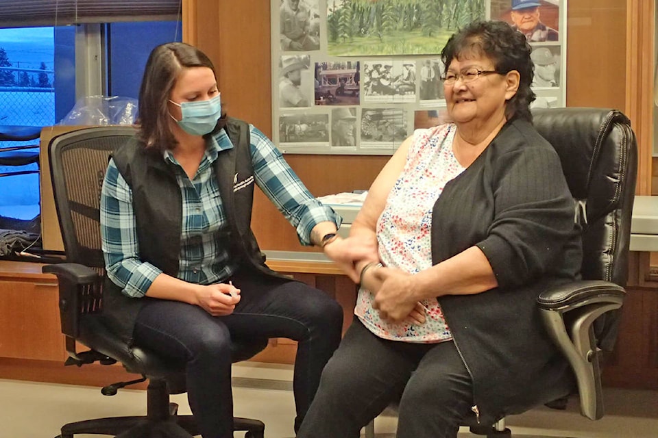 Ulkatcho First Nation elder Mary William receives the first COVID-19 vaccine in Anahim Lake. (Jamie E Tanis photo)