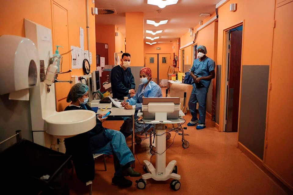 Student nurse Soraya Ngin Tun, left, Dr. Atanas Sabahov, center left, nurse Rim Omrani, center right, and student nurse Landry Nzoyem, right, rest at Bichat Hospital, AP-HP, in Paris, Thursday, April 22, 2021. France still had nearly 6,000 critically ill patients in ICUs this week as the government embarked on the perilous process of gingerly easing the country out of its latest lockdown, too prematurely for those on pandemic frontlines in hospitals. President Emmanuel Macron’s decision to reopen elementary schools on Monday and allow people to move about more freely again in May, even though ICU numbers have remained stubbornly higher than at any point since the pandemic’s catastrophic first wave, marks another shift in multiple European capitals away from prioritizing hospitals. (AP Photo/Lewis Joly)