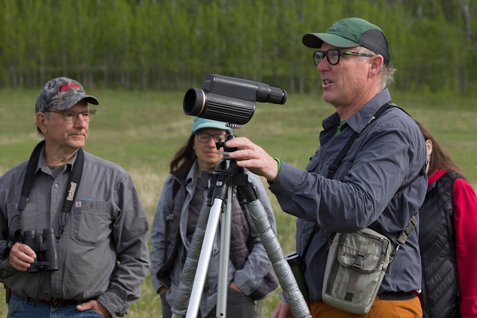 Ken MacKenzie, right, discusses the different type of bird song during a birding and botanical walk at the Horse Lake Community Farm Co-Op. Glenn Ehlers, left, and Kristi Iverson look on. (Kelly Sinoski photo - 100 Mile Free Press)