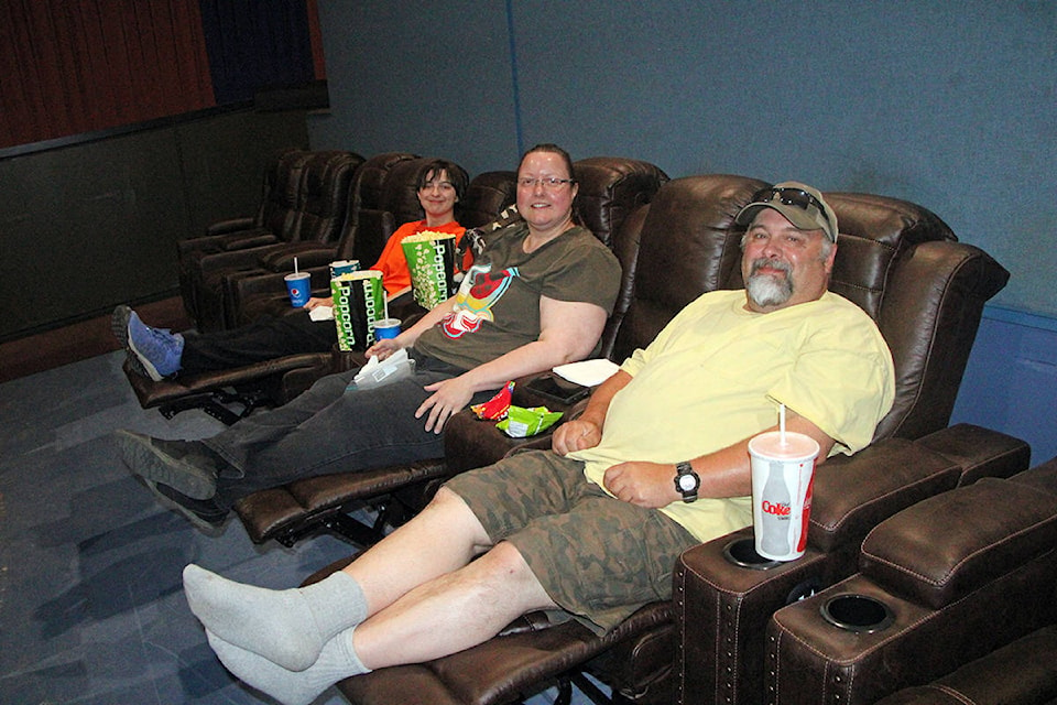 Marc Spender, right, loves the new seats at the South Cariboo Theatre, a sentiment shared by his family Tara Spender and Kaedence Spender. (Patrick Davies photo - 100 Mile Free Press)