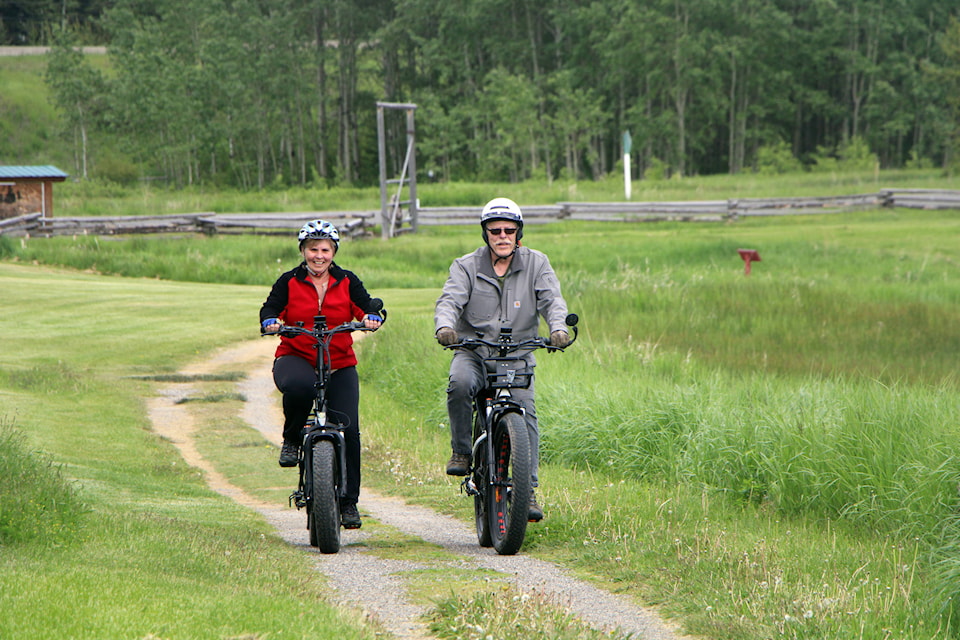 Jesse Mahoney and Lynda Mahoney loves riding their E-Bikes on a near-daily basis, often around their home in 108 Mile Ranch. (Patrick Davies photo - 100 Mile Free Press)