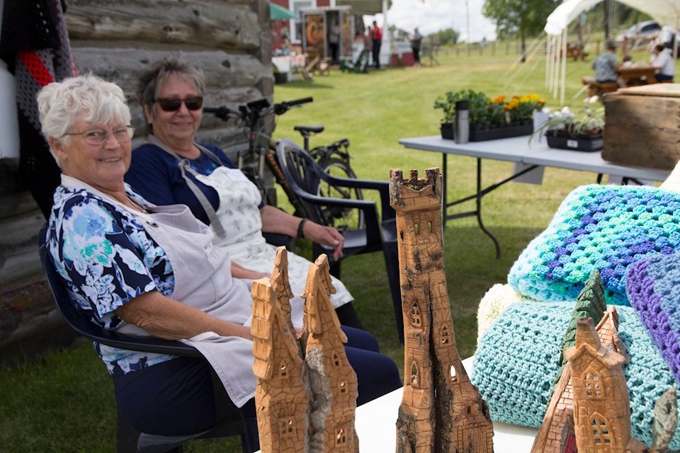 Maggie Pugh and Marianne Lawrence find the Heritage Market is a great place to hang out and visit. (Kelly SInoski photo -100 Mile Free Press).