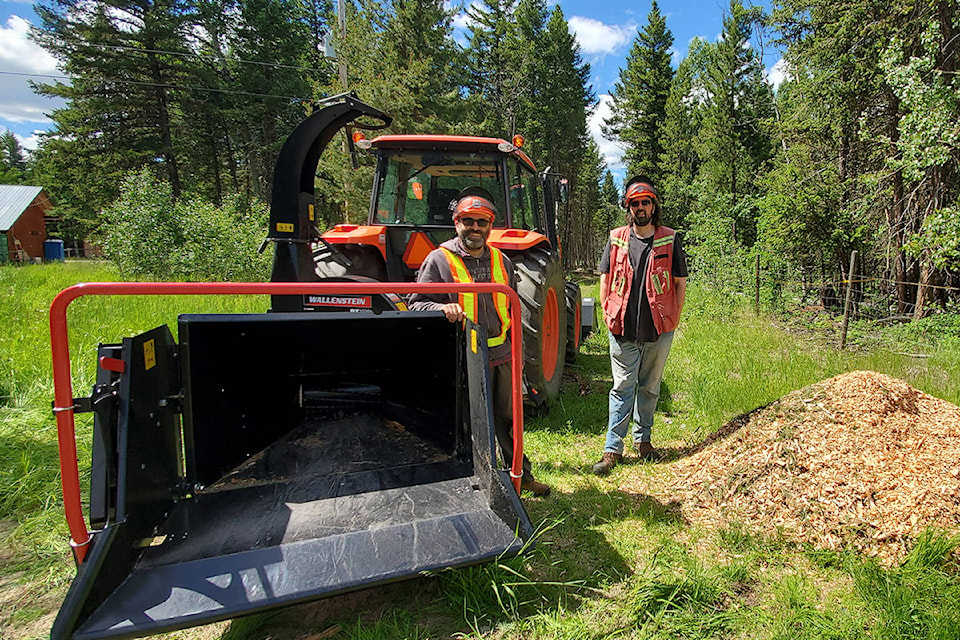 Marian Marinescu, left, and Stuart Spencer, of FP innovations with one of three chippers used in a trial at the UBC Research Forest property on Fox Mountain.