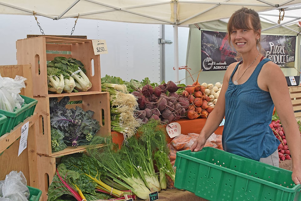 Owner/operator of Puddle Produce Farm Brianna van de Wijngaard sells produce Friday, July 16 at the Williams Lake Farmers’ Market. (Rebecca Dyok photo)
