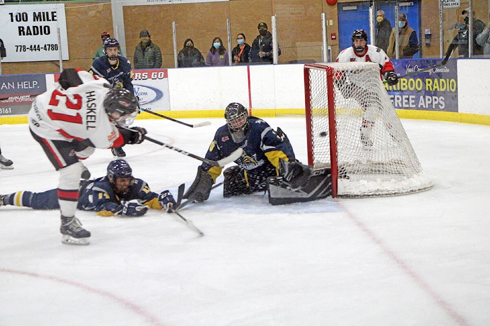 Brayden Haskell takes a shot on Casey Thomson during the 100 Mile House Wrangler’s season-opening game on Saturday. Thomson went on to win player of the game after blocking 38 of 43 shots on net. (Patrick Davies photo - 100 Mile Free Press)