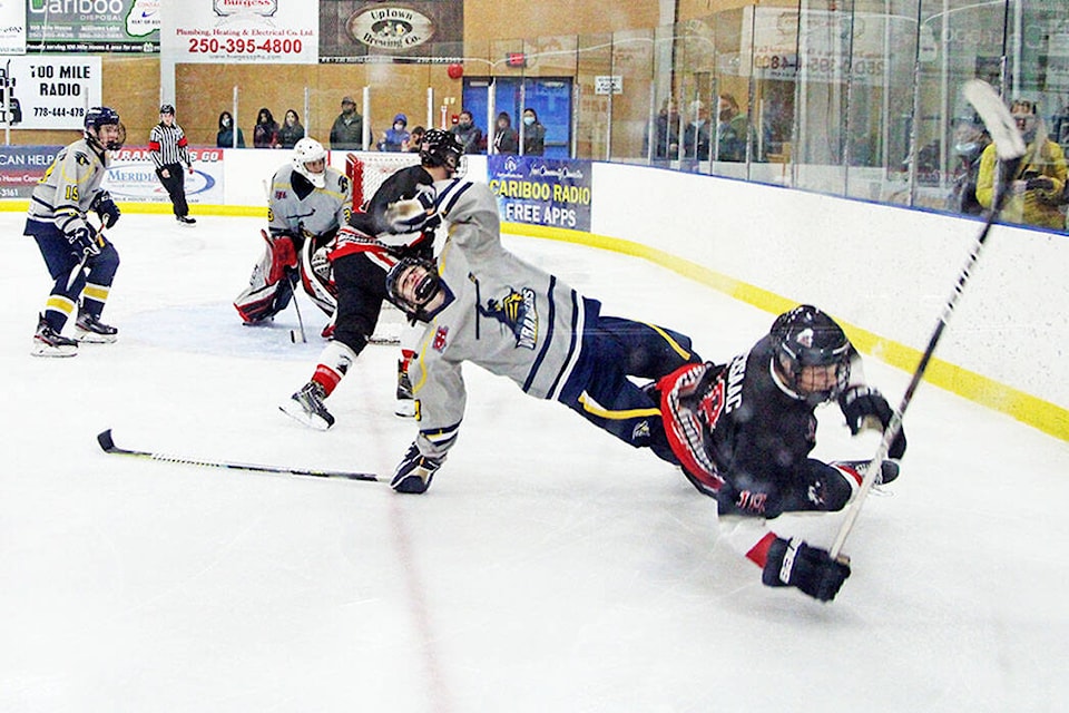 Curtis Coffin of the 100 Mile House Wranglers goes down after colliding into Nat McIssac of the Summerland Steam. (Patrick Davies photo - 100 Mile Free Press)