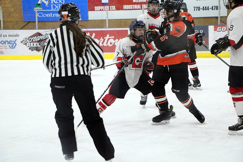 Members of the U18 Merrit team clash against the U18 Salmon Arm team at a tournament in 100 Mile House. (Patrick Davies photo - 100 Mile Free Press)