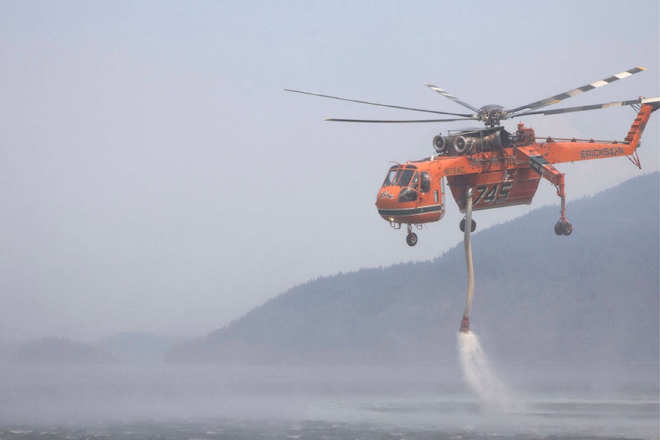 A helicopter collects water at Canim Lake to help battle a nearby fire July 8. (Kelly Sinoski photo - 100 Mile Free Press).