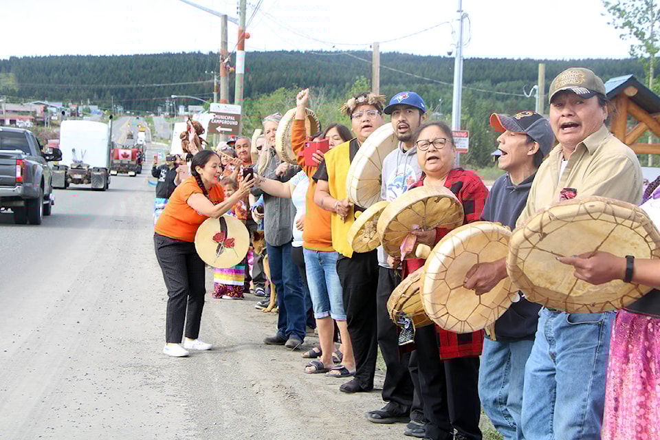 Members of the Canim Lake Band and 100 Mile House community welcome a convoy of trucks passing through town on the way to the Kamloops Residental School. (Patrick Davies photo - simplymastery)