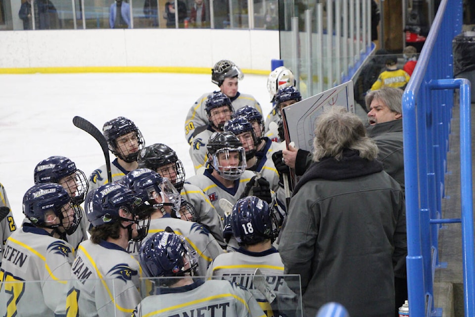 During a timeout, the 100 Mile House Wranglers listen intently as coach Dale Hladun lays out their game plan. (Patrick Davies photo - simplymastery)