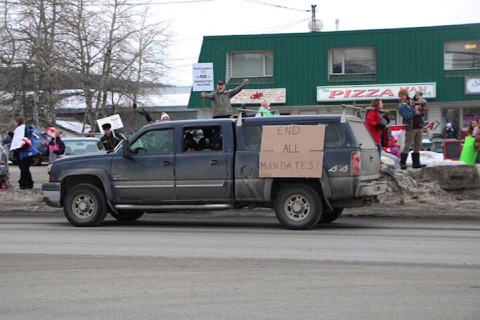 Supporters of the Freedom Convoy turned out for a Slow Roll protest and demonstration Saturday along Highway 97. Roughly 200 people lined the highway waving Canadian flags and carrying signs calling for an end to vaccine mandates while 100 trucks and cars through town, honking their horns the entire way. (Patrick Davies photo - 100 Mile Free Press)
