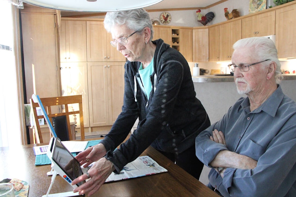 Louise Greenwood sets up her and her husband Bruce Greenwood’s new Optelec Compact 10” HD Speech Electronic Magnifier while he watches. (Patrick Davies photo - 100 Mile Free Press)