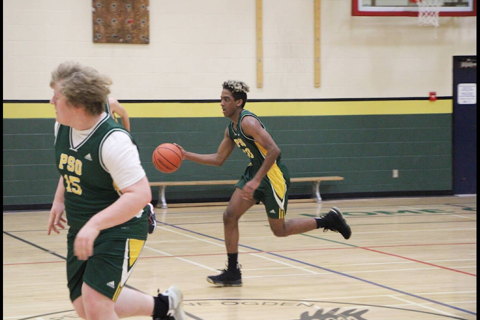 Mohamed Omer dribbles the ball down the court at Peter Skene Ogden Secondary School. (Patrick Davies photo - 100 Mile Free Press)