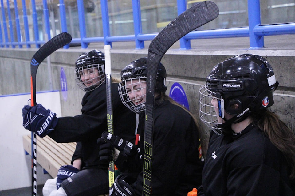 Vanessa Betschart, Megan Balbirnie and Melody Watkins share a laugh as they sit on the bench during a scrimmage practice last week. (Patrick Davies photo - 100 Mile Free Press)