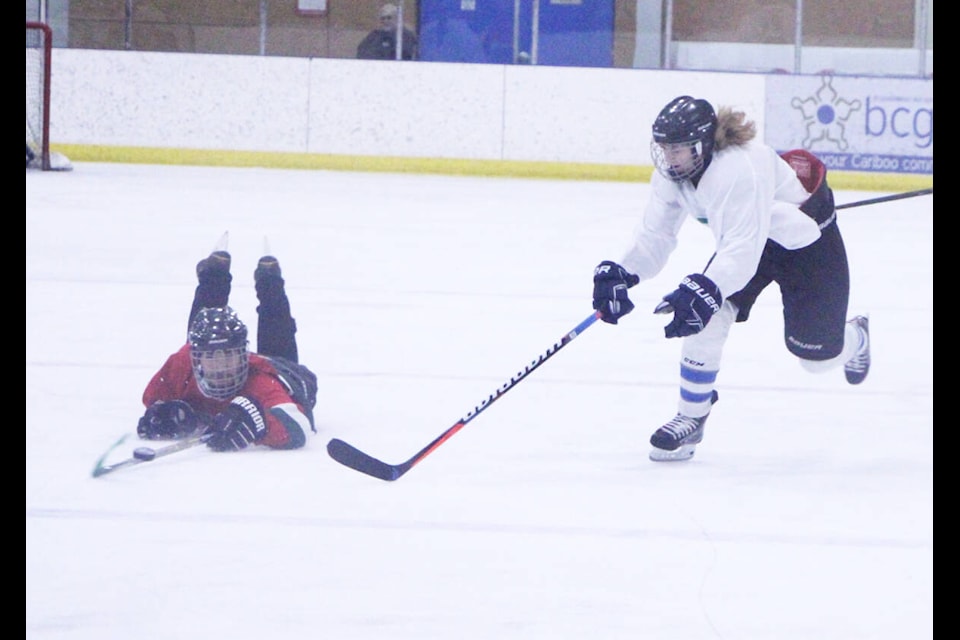 Kameron Taylor dives in front of Vanessa Betschart’s puck during PSO’s Grads vs Teachers hockey game last week. (Patrick Davies photo - simplymastery)