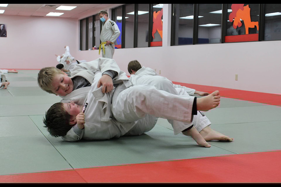 Brothers John and Dylan Andrews practice a hold during Kokoro Judo Club’s youth class March 9. SEE story A21. (Melissa Smalley photo - simplymastery)
