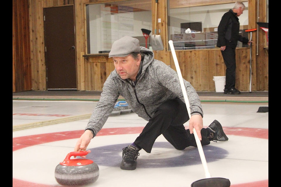 Allan Faulkner glides across the ice as he throws a rock during the Men’s League Playoffs last Wednesday. (Patrick Davies photo - simplymastery)