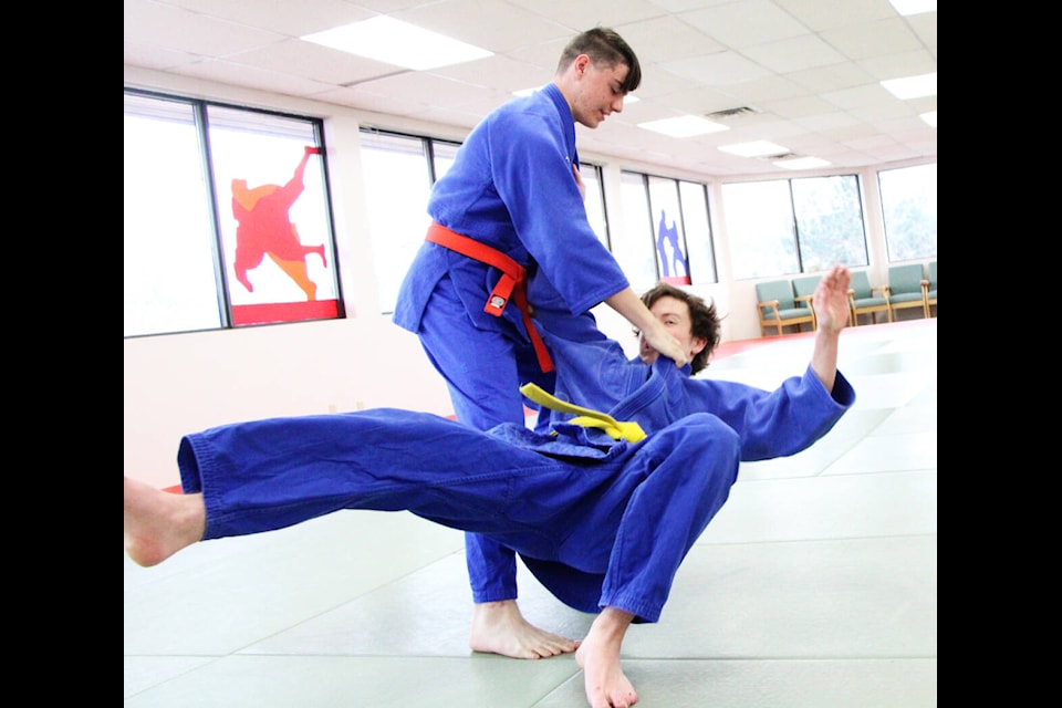 Maxi Springmann practices flipping Will McKenzie to the mats at Koro Judo 100 Mile House. (Patrick Davies photo - 100 Mile Free Press)