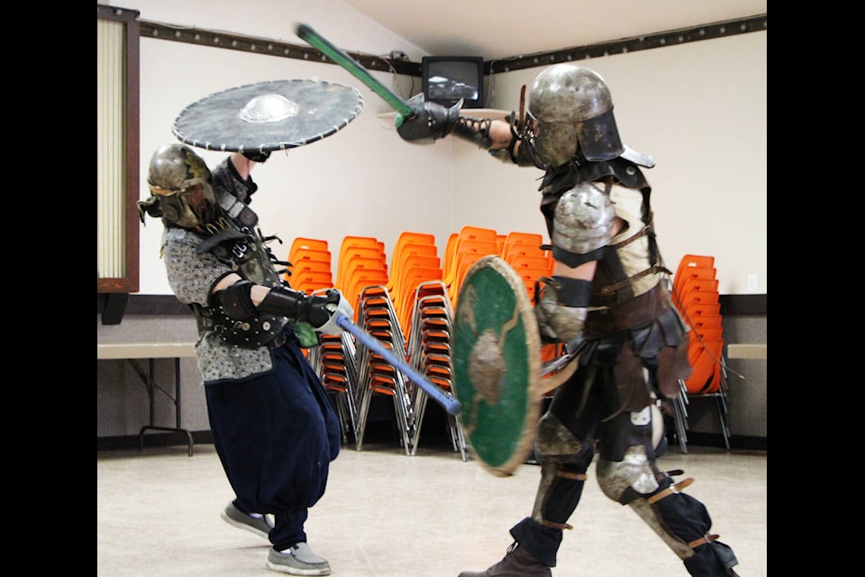 Miles Theoret and Charles Jones blocks one another’s attacks with their shields during a practice bout last Tuesday. (Patrick Davies photo - 100 Mile Free Press)