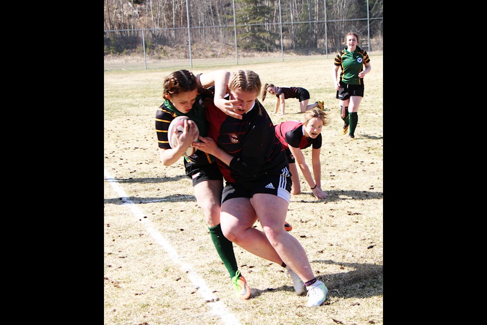 PSO Eagles senior captain Emily Machado grapples with LCSS Falcons’ player Taryn Hincshe during the 100 Mile House Girls Rugby Jamboree. (Patrick Davies photo - 100 Mile Free Press)