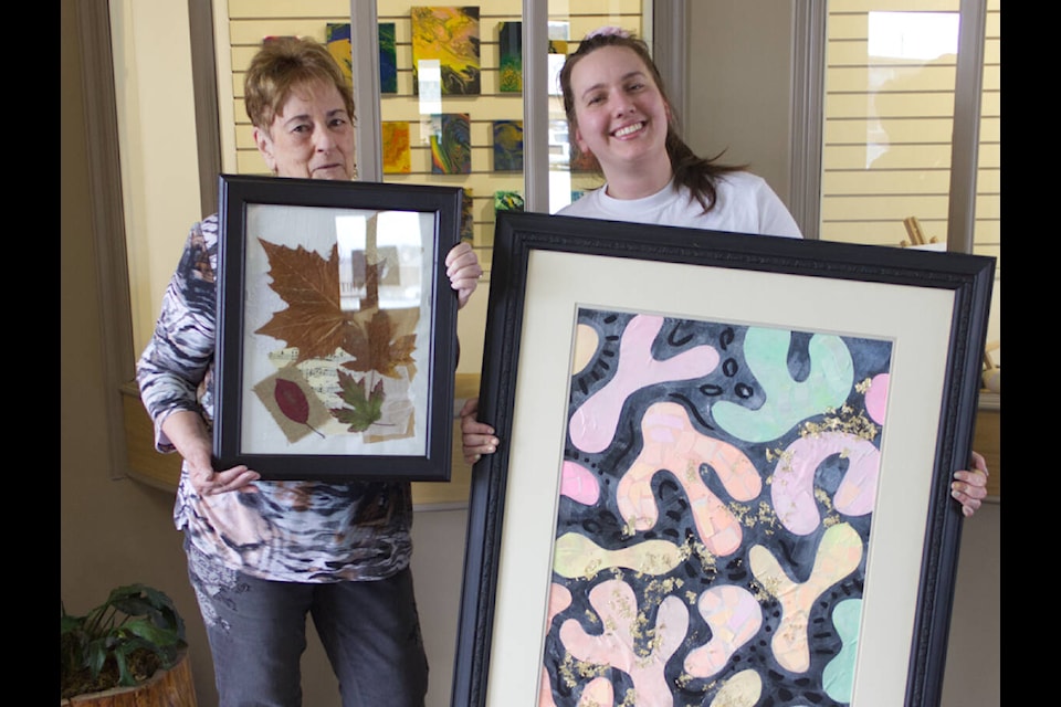 Carol Munro, left, and Jessica Thomas show off their mixed-media art at Showcase Gallery. (Lauren Keller photo- 100 Mile Free Press)