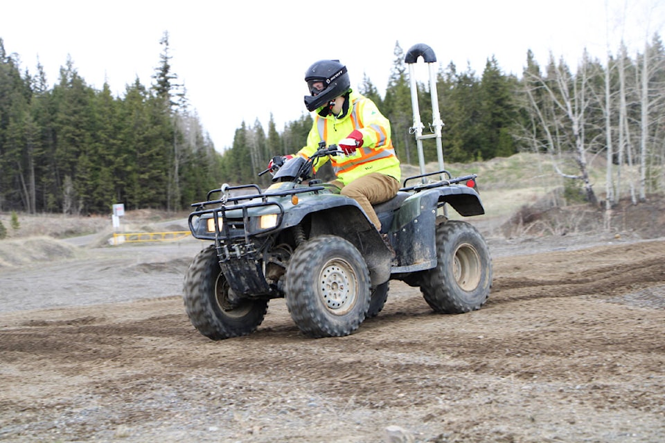 Dylan Strelaeff, one of West Fraser’s summer students, rides his ATV on a figure-eight track during a safety training course last week. (Patrick Davies photo - 100 Mile Free Press)