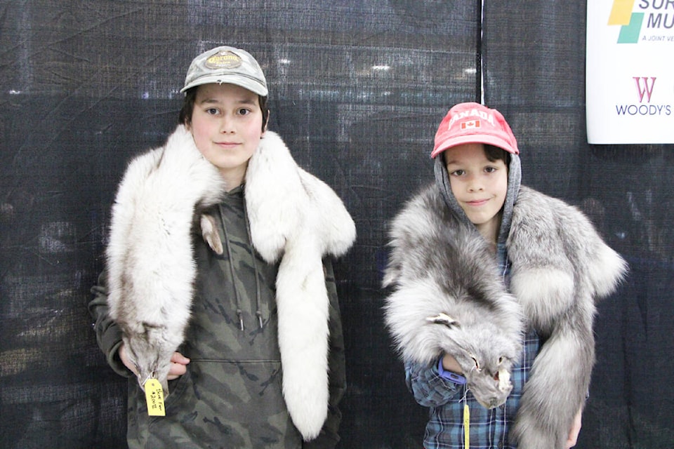 Jackson and Bentley Lipsett both purchased their own furs at the BC Trappers Association Convention on Saturday. (Patrick Davies photo - 100 Mile Free Press)