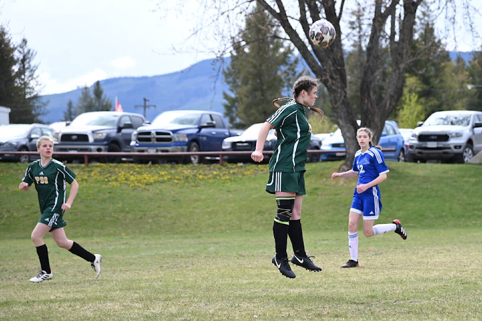A 100 Mile player makes a header in soccer action. (Stephanie Hagenaars photo - Black Press Media).
