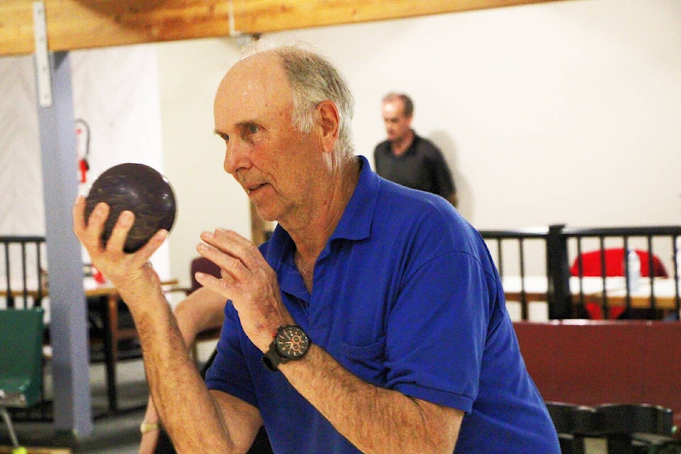 Bob Allen judges the weight of a bowling ball as he prepares to throw it at Big Country Lanes. (Patrick Davies photo - 100 Mile Free Press)