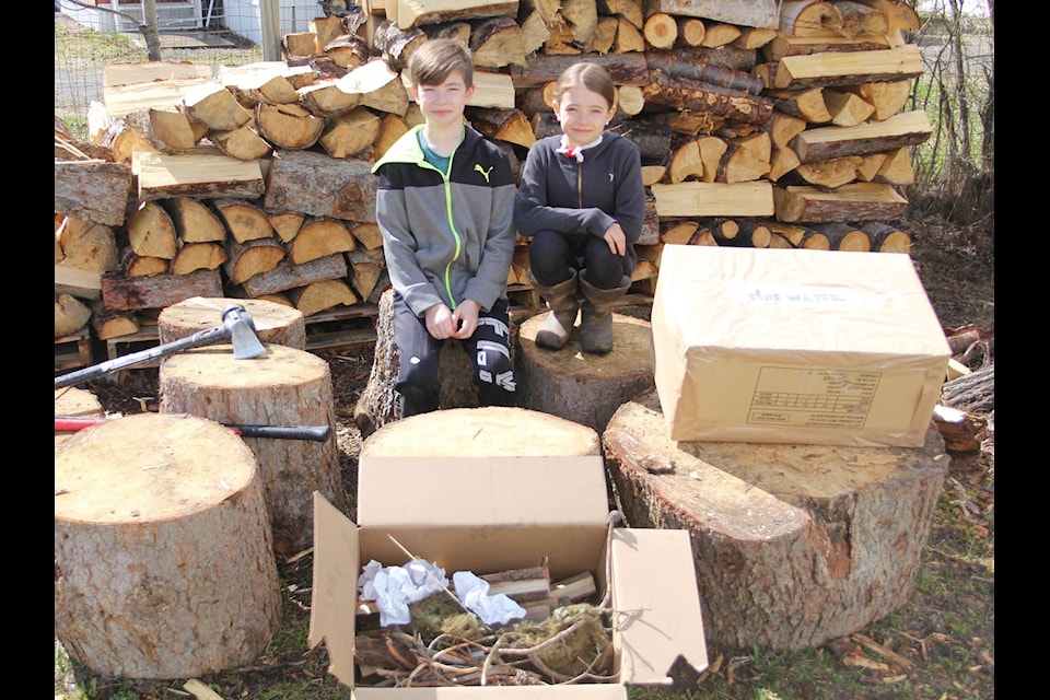 Elias, left, and Kodi Nelson make 1 Match Boxes with their dad. (Lauren Keller photo - 100 Mile Free Press)