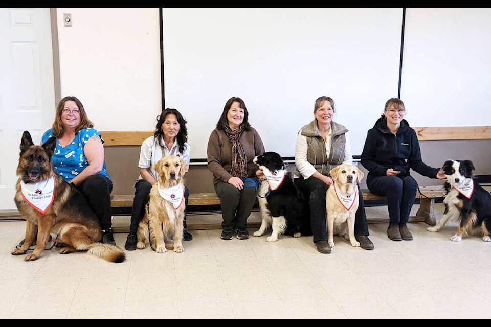 Handlers pose with ther newly-certified St. John Ambulance therapy dogs who were evaluated at the 150 Mile House fire hall. Kimberly Futcher with Ede, left, Karen Wright with Maya, Colleen Hodgson with Tuck, Patricia Moore with Emma, Wendy Chevigny with Mogli. (Photo submitted)