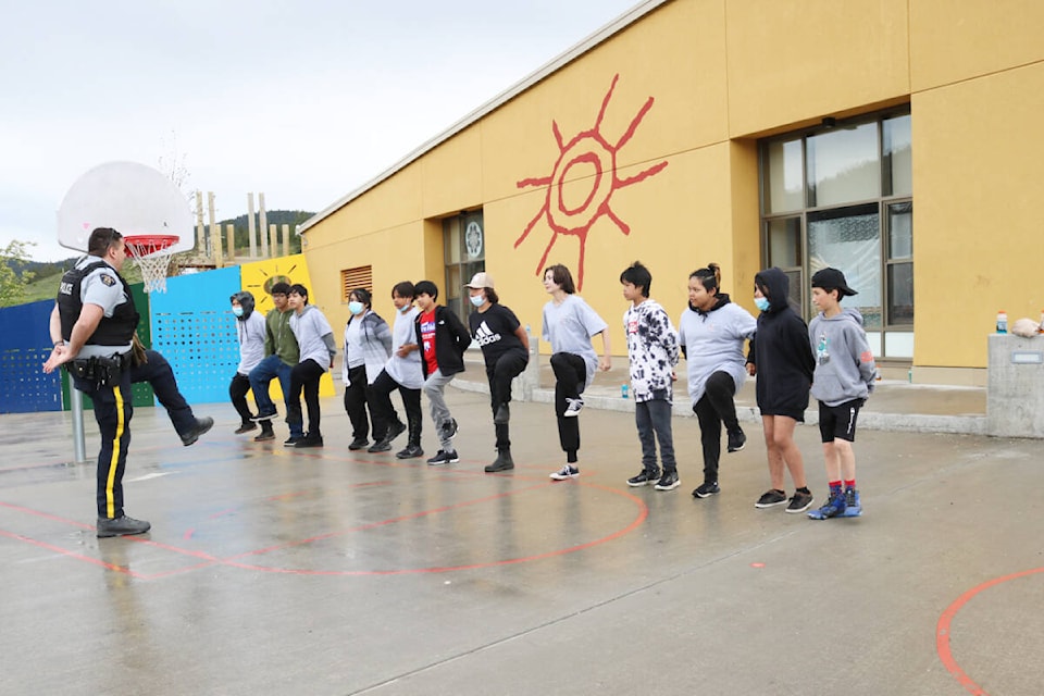 Williams Lake RCMP Const. Nick Brown of the Cariboo Chilcotin Crime Reduction Unit takes students through a marching drill. (Photo submitted)