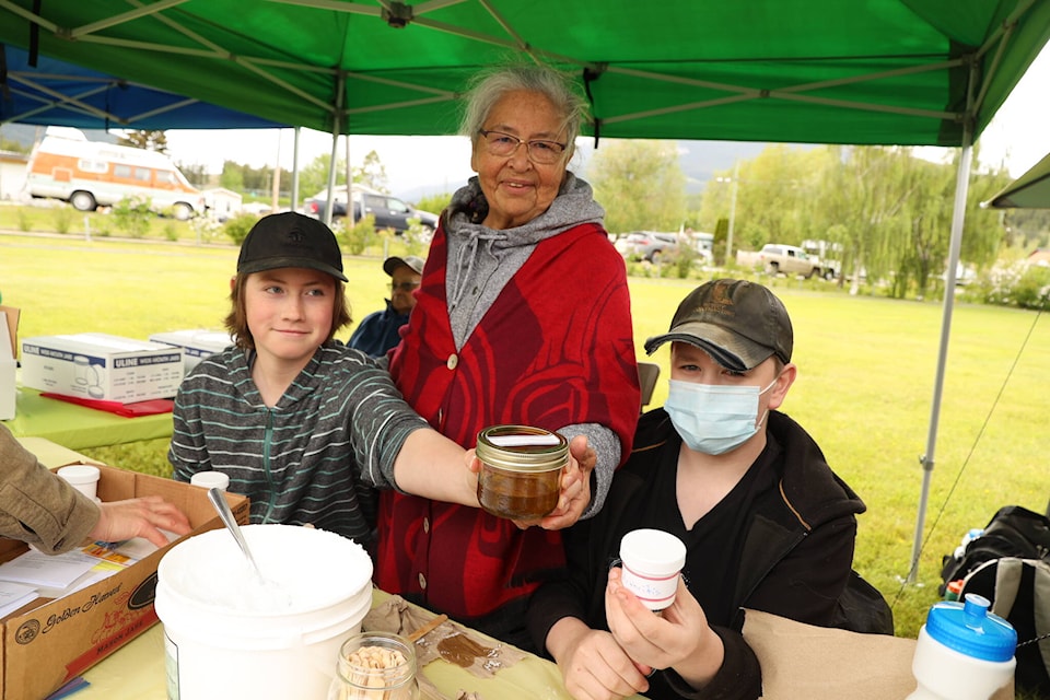 Liam Brehm, left, Julie Antoine and Nolan Hughes, offer free plant-based medicines that they made at David Stoddart School this year. Antoine, of Bonaparte, provides medicine-making classes to schools in Ashcroft, Cache Creek and Clinton. (Kelly Sinoski photo - 100 Mile Free Press)