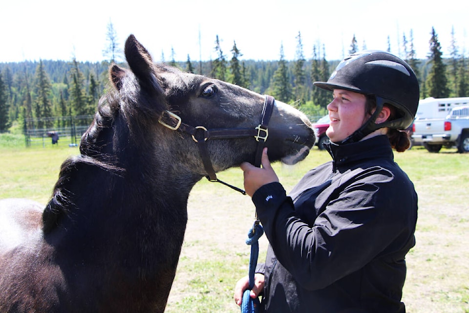 Erica Smith laughs as she attempts to give her horse Jonesy a kiss. (Patrick Davies photo - 100 Mile Free Press)