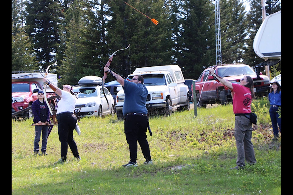 Attendees of the Big Horn Archery Club’s annual Traditional Shoot take aim at a bowbird, a foam disc being launched by a machine skeet shoot style. (Patrick Davies photo - 100 Mile Free Press)