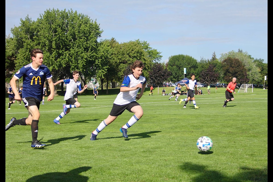 Griffin Carmont, a defender on Williams Lake FC, races down the sidelines to beat a Pinnacles FC player to the ball. (Lauren Keller photo - simplymastery)