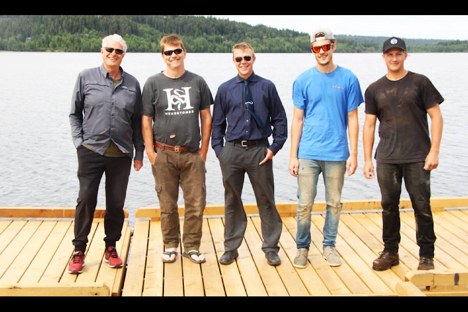 L-r: Freshwater Fisheries Society of B.C. contractor Ian McGregor, 108 Mile Ranch beach attendant Darren Paulson, Cariboo Regional District’s Darron Campbell and New Wave Docks’ workers Dylan McNeil and Brett Alexander show off the new dock at 108 Mile Lake. (Patrick Davies photo - 100 Mile Free Press)