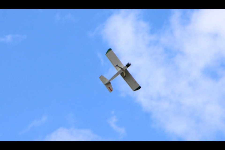 A model airplane soars in the sky above 100 Mile House last weekend. (Patrick Davies photo - 100 Mile Free Press)