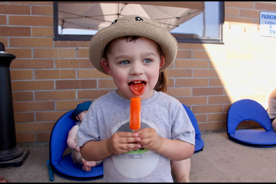 Cosmo Groeneveld enjoys a popsicle on a hot day at the Kids on Wheels event at the Cariboo Family Enrichment Centre. (Lauren Keller photo - 100 Mile Free Press)